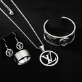 Luxury monogram white gold jewelry set on black velvet