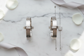 Matching his and hers white gold couples jewelry set on marble